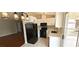 Updated kitchen features white cabinetry, modern appliances, and access to backyard patio at 275 Las Palmaritas Dr, Las Vegas, NV 89110