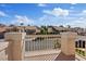 Balcony view of nearby neighborhood showcasing homes with tile roofs, blue sky and green trees at 2812 Via Avanti St, Henderson, NV 89074