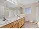 Spacious bathroom featuring a double sink vanity, a large mirror, and a shower/tub combo at 2812 Via Avanti St, Henderson, NV 89074