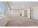 Bright and airy bedroom with carpet, ceiling fan, closet, and natural light from the large window at 2812 Via Avanti St, Henderson, NV 89074