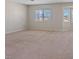 Spacious bedroom featuring neutral walls, carpet, and ample natural light through large windows at 2812 Via Avanti St, Henderson, NV 89074