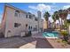 Stunning exterior view featuring a backyard pool, mature palm trees, and well-maintained landscaping at 2812 Via Avanti St, Henderson, NV 89074