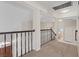 Carpeted upper hallway with dark railing and multiple rooms leading to other areas of the home at 2812 Via Avanti St, Henderson, NV 89074