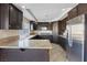 Spacious kitchen features granite counters, stainless steel appliances, and custom dark wood cabinetry at 2812 Via Avanti St, Henderson, NV 89074