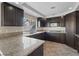 Charming kitchen featuring tile flooring, granite countertops, stainless appliances, and wood cabinets at 2812 Via Avanti St, Henderson, NV 89074