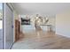Spacious living room with fireplace, staircase, wood floors, and sliding glass doors at 2812 Via Avanti St, Henderson, NV 89074