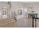 Open living room features tile floors, a fireplace, arched windows, and a staircase at 2812 Via Avanti St, Henderson, NV 89074