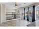 Bright living room with tile flooring, ceiling fan, large windows, and views of the pool at 2812 Via Avanti St, Henderson, NV 89074