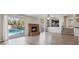 Living room features a brick fireplace, wood floors, and sliding glass doors leading to the pool at 2812 Via Avanti St, Henderson, NV 89074