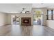 Bright living area with fireplace, laminate flooring, and sliding glass doors to the outdoor pool at 2812 Via Avanti St, Henderson, NV 89074