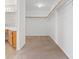 Carpeted walk-in closet with custom built-in shelving and ample storage space at 2812 Via Avanti St, Henderson, NV 89074