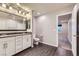 Modern bathroom with double sink vanity, decorative lighting, and access to bedroom at 2878 Via Firenze, Henderson, NV 89044