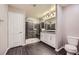 Modern bathroom with double sink vanity, large shower, and tile flooring at 2878 Via Firenze, Henderson, NV 89044