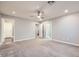 Large bedroom with carpet, ceiling fan, and views to a walk-in closet and ensuite bathroom at 2878 Via Firenze, Henderson, NV 89044