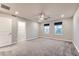 Large bedroom with carpet, ceiling fan and two windows, located next to a walk-in closet at 2878 Via Firenze, Henderson, NV 89044