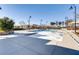 Community pool with ample concrete decking, landscaping, shaded seating, and perimeter fencing at 2878 Via Firenze, Henderson, NV 89044