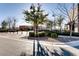 Community courtyard featuring trees, shrubs, covered walkways and stone architecture at 2878 Via Firenze, Henderson, NV 89044