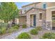 Charming two-story home with stone accents, a well-manicured yard, and a welcoming front entrance at 2878 Via Firenze, Henderson, NV 89044