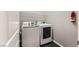 A well-equipped laundry room with modern washer and dryer units for convenience at 2878 Via Firenze, Henderson, NV 89044
