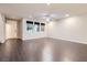 Spacious living room features wood-style flooring and bright windows, perfect for relaxing or entertaining at 2878 Via Firenze, Henderson, NV 89044