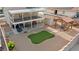 An aerial view of the backyard with gravel, a patch of artificial turf, a shed, and a covered outdoor seating area at 3008 Soledad Dr, Laughlin, NV 89029