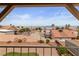 Landscaped backyard view with decorative wagon wheels, rock ground cover, and mountain scenery at 3008 Soledad Dr, Laughlin, NV 89029