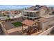 This backyard features gravel, a pergola with seating, artificial turf, a shed, and a covered two-story patio at 3008 Soledad Dr, Laughlin, NV 89029