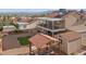 Aerial view of the backyard with gravel, a patch of artificial turf, a shed, and a covered outdoor seating area at 3008 Soledad Dr, Laughlin, NV 89029
