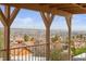 Balcony with wooden beams overlooking houses with tiled roofs and city view with mountains in the distance at 3008 Soledad Dr, Laughlin, NV 89029