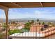 Balcony with metal bars overlooking houses with tiled roofs and city view with mountains in the distance at 3008 Soledad Dr, Laughlin, NV 89029