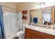 Bathroom features a walk-in shower, toilet, wood vanity with granite countertop and a decorative mirror at 3008 Soledad Dr, Laughlin, NV 89029