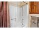 Shower with tub and shower head, accented by rustic wood paneling and soft textures at 3008 Soledad Dr, Laughlin, NV 89029