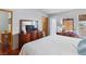 Well-lit bedroom featuring a plush bed, matching wooden furniture, neutral walls, and hardwood floors at 3008 Soledad Dr, Laughlin, NV 89029