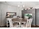 Charming dining room features a wooden table, chandelier, and unique built-in fish tank at 3008 Soledad Dr, Laughlin, NV 89029