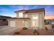 Charming two-story home featuring a tile roof, well-kept landscaping, and an attached garage at 3008 Soledad Dr, Laughlin, NV 89029