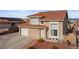 Charming two-story home with a tile roof, desert landscaping, and a cozy front bench at 3008 Soledad Dr, Laughlin, NV 89029