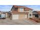 Charming two-story home featuring a red tile roof, attached garage, and low maintenance desert landscaping at 3008 Soledad Dr, Laughlin, NV 89029