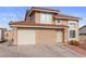 Charming two-story home featuring a red tile roof, attached garage, and low maintenance desert landscaping at 3008 Soledad Dr, Laughlin, NV 89029