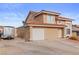 Charming two-story home featuring a red tile roof, attached garage, and low maintenance desert landscaping at 3008 Soledad Dr, Laughlin, NV 89029