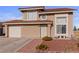 Charming two-story home featuring a red tile roof, attached garage, and low maintenance desert landscaping at 3008 Soledad Dr, Laughlin, NV 89029