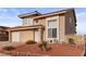 Charming two-story home featuring a red tile roof, attached garage, and low maintenance desert landscaping at 3008 Soledad Dr, Laughlin, NV 89029