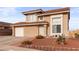 Charming two-story home featuring a red tile roof, attached garage, and low maintenance desert landscaping at 3008 Soledad Dr, Laughlin, NV 89029
