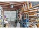Garage interior featuring a white door, ceiling-mounted opener, and disorganized storage at 3008 Soledad Dr, Laughlin, NV 89029