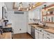 Well-lit kitchen with stainless steel appliances, custom cabinets, and rustic ceiling beams at 3008 Soledad Dr, Laughlin, NV 89029