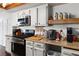 Galley kitchen with stainless appliances, gas range, butcher block countertop and white cabinetry at 3008 Soledad Dr, Laughlin, NV 89029