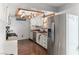 Well-lit kitchen with stainless steel appliances, custom cabinets, and rustic ceiling beams at 3008 Soledad Dr, Laughlin, NV 89029