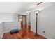 A loft space is accented by hardwood floors, white walls, a wooden railing and a small window at 3008 Soledad Dr, Laughlin, NV 89029