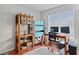 Home office with natural light, computer setup, wooden shelves, and comfortable workspace at 3008 Soledad Dr, Laughlin, NV 89029