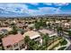 Expansive aerial shot showcases a well-planned community with lush greenery and scenic mountain views at 301 Lakewood Garden Dr, Las Vegas, NV 89148
