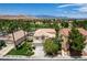 Aerial view of well-maintained home, manicured lawn, mature trees, and mountain views in a desirable community at 301 Lakewood Garden Dr, Las Vegas, NV 89148